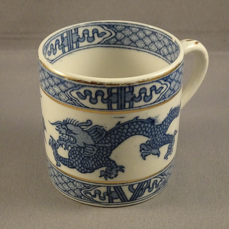 Booth's coffee cup or can, of straight-sided form, with underglaze blue transfer design of chinoiserie Dragons and lattice edging, with gilt lines.
